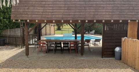 Gated swimming pool and shaded barbecue area in the gardens of Pie Pasquie.